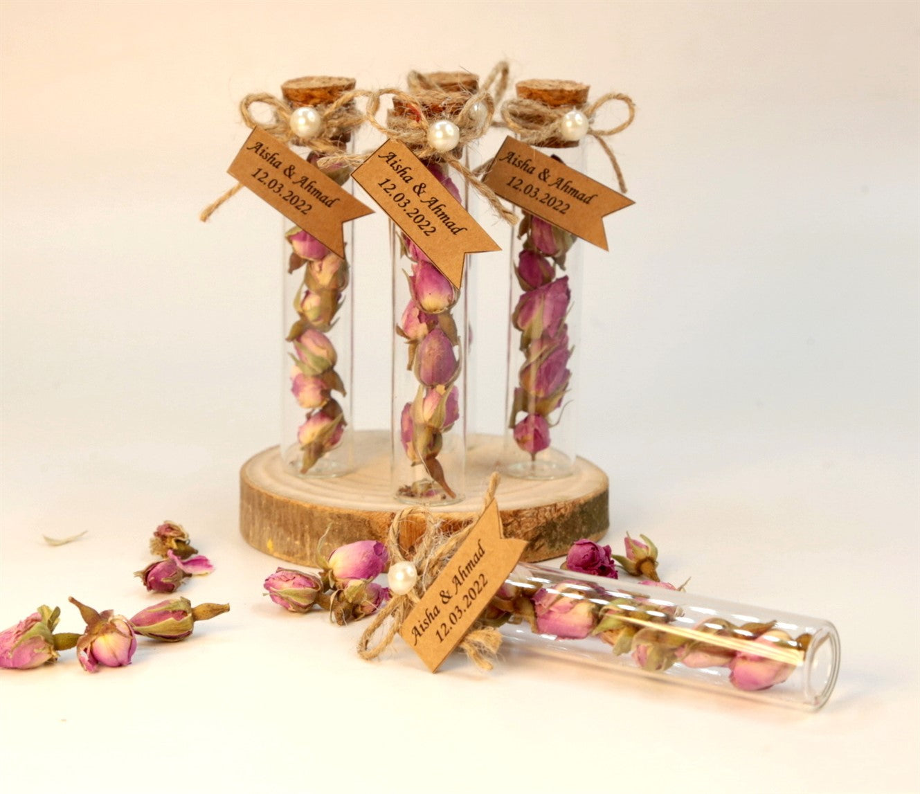 Personalisierte Glasröhrchen mit getrockneten Rosenknospen und Namensschild